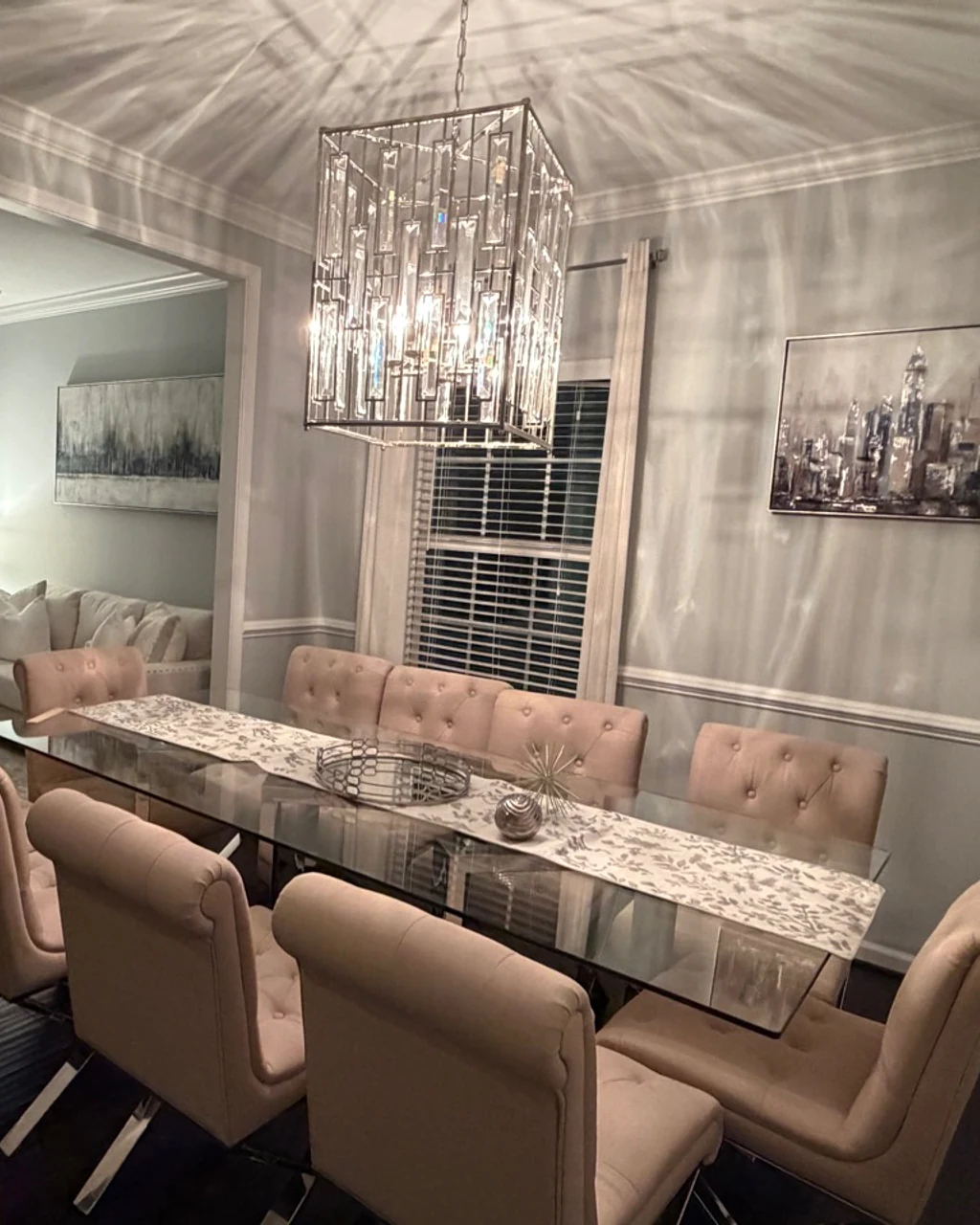 Finished formal dining room with polished glass table and seating